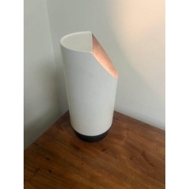 Gerald Thurston off white powder coated aluminum canister lamp that reflects light from the back of the lamp. The lamp can...