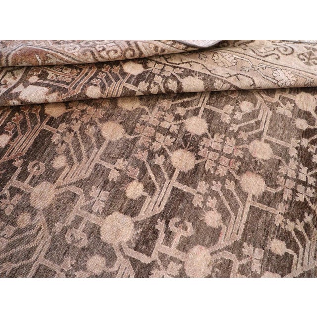A masterwork of subtle elegance and cultural synthesis, this vintage Khotan "Samarkand" rug-handwoven in East Turkestan...