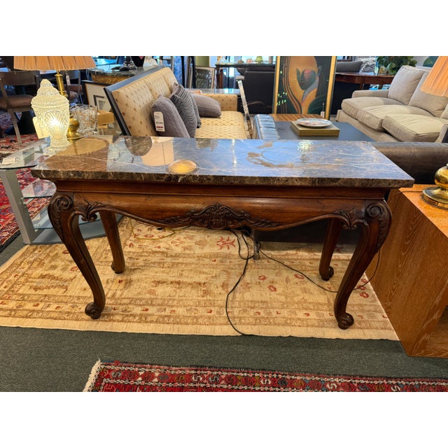 Design Plus Gallery presents a Carved Wood Console with Marble Top from Hekman Furniture Company. The console has classic...