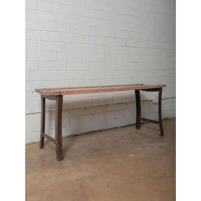 A study in raw materiality, this bench brings together a weathered iron frame and sun-faded timber slats, each surface...
