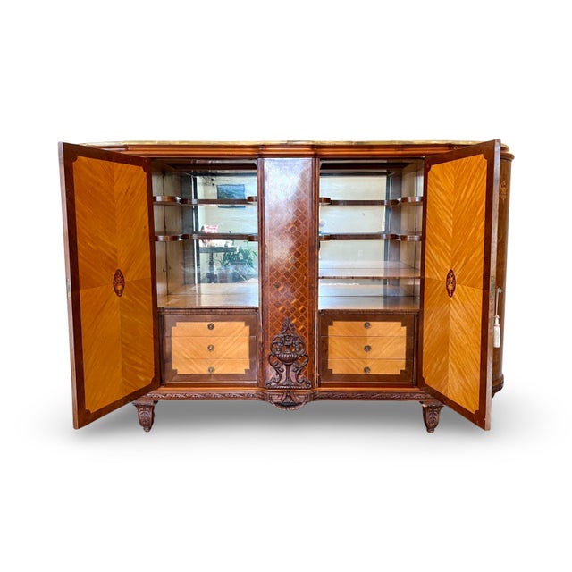 A striking blend of Italian craftsmanship and French Art Deco design, this grand vintage sideboard is a true showpiece....