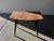 A compact Mid-Century occasional table featuring a solid timber plank-effect top with softly rounded corners and gently...