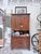 Built from solid pine, the hutch rises in a tall, balanced silhouette: two upper doors, two drawers, and two lower doors...
