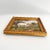 A signed pastoral landscape with a sheep grazing in a wildflower field. Framed in a gold frame. Illegibly signed. Size:...