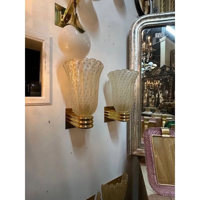 Nice pair of modern Murano glass and brass cup sconces. Circa 2000. The sconces have been professionally rewired and ready...