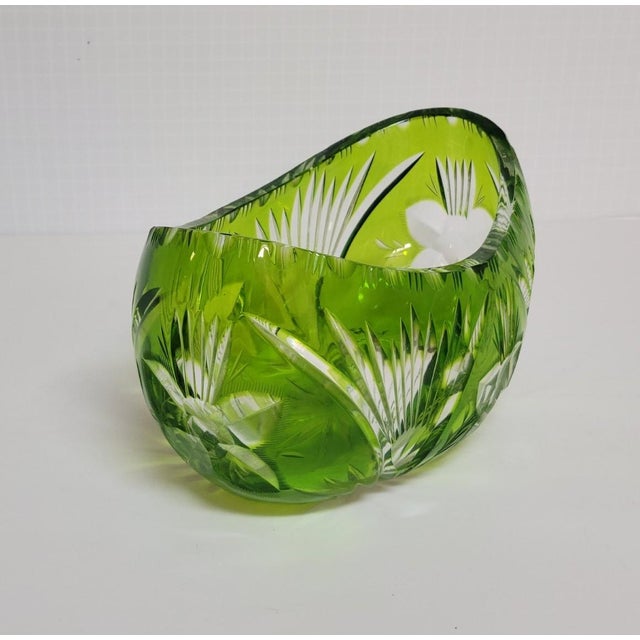 A sculptural mid-20th century cut-to-clear crystal bowl in a vivid apple green overlay, cut through to clear with deep...