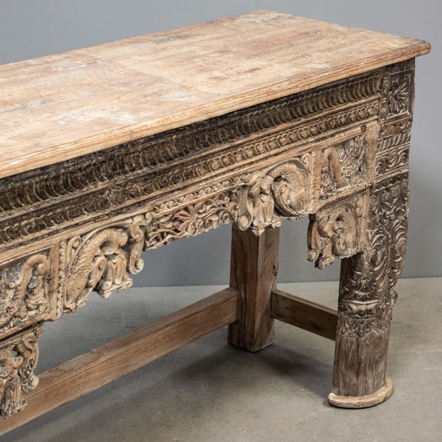 Hand carved teak console table from Rajasthan, India made from antique architectural remnants. The legs, made from antique...