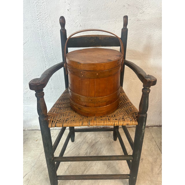 This is a charming antique high-back child’s chair, likely from the 19th or early 20th century. Here’s a detailed...