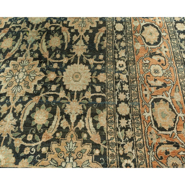 A late 19th century antique Persian Kirman rug, the midnight field with an allover herati design in shades of pale apricot...