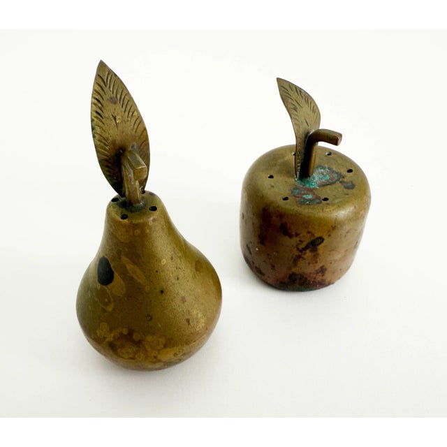 Immensely charming apple and pear form salt and pepper set made of solid brass with rich patina. Likely produced in the...