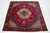 This Vintage Tabriz wool rug has a red field, a green border, and multicolor accents all over the rosette motif. This rug...