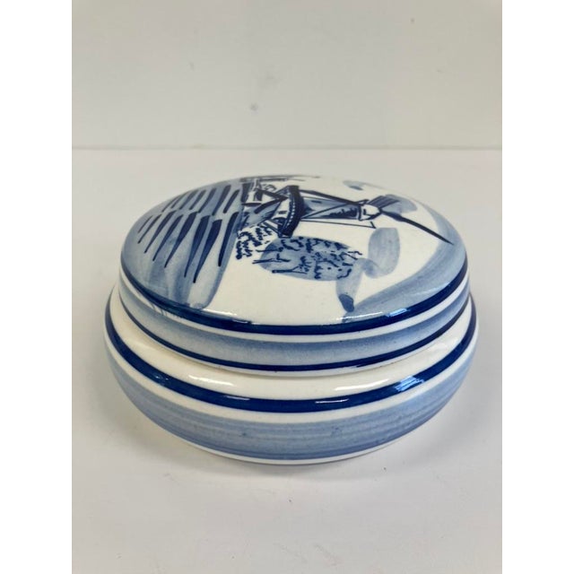 Vintage blue and white ceramic trinket box with a hand-painted windmill and landscape scene. Likely dating from the...
