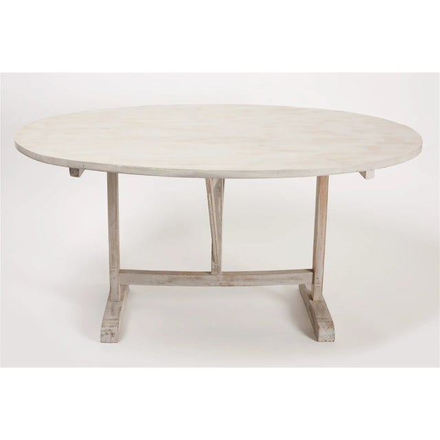 Vintage French tilt top wine table, painted white. Poplar top and oak base. Base is perhaps antique, top has been newly...