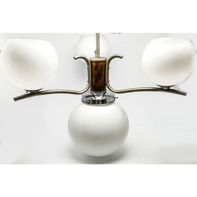 The pendant lamp was produced in the 50s. The design is brass and covered with chrome, glass shades. It is preserved in...