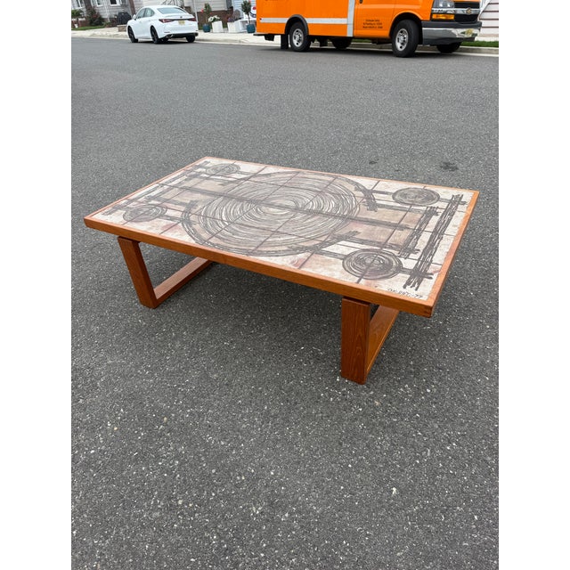 Mid century Danish coffee table. The table is made by Trioh in Denmark with a stunning Ox Art tile inlay design. The table...