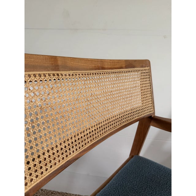 Very sturdy solid wood frame with cane back. Fabric cover seat cushion. MCM playboy style chair. The measurements of the...