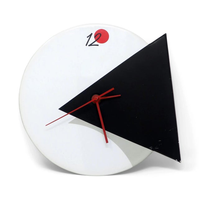 A striking postmodern, Memphis-inspired wall clock by Small World Greetings. White vinyl face with inset black triangle,...
