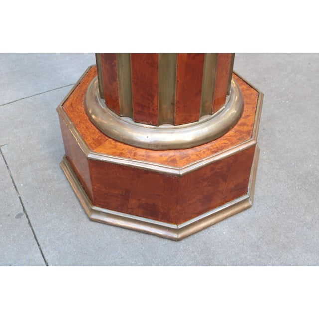Pair of neoclassical-style pedestals. Birds eye maple with inlaid patinated brass details and patinated brass trim around...