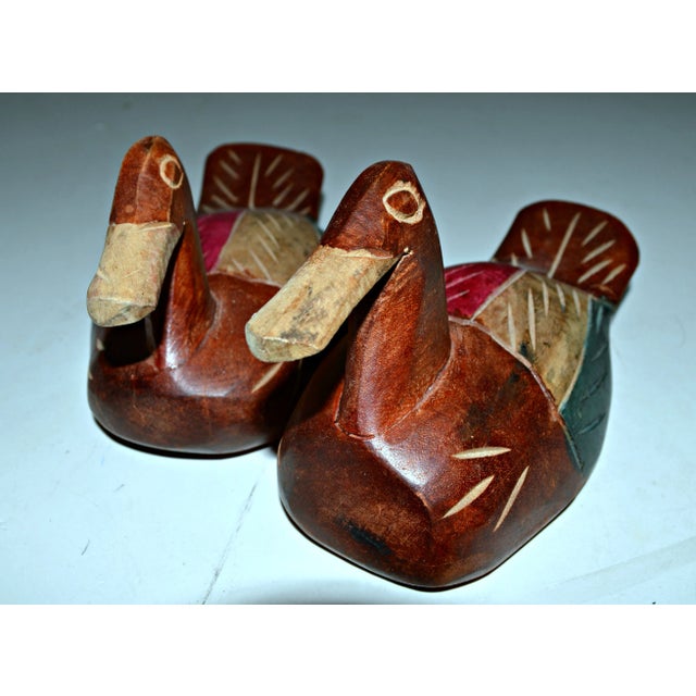Pair of carved wood decoys painted with natural pigments. Smaller, 7"L x 3.5"W x 3.5"H.
