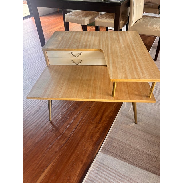 Set of 2 Mid-Century Modern Tiered Coffee Tables, photos attached. These cerca 1950s tiered coffee tables have a light...