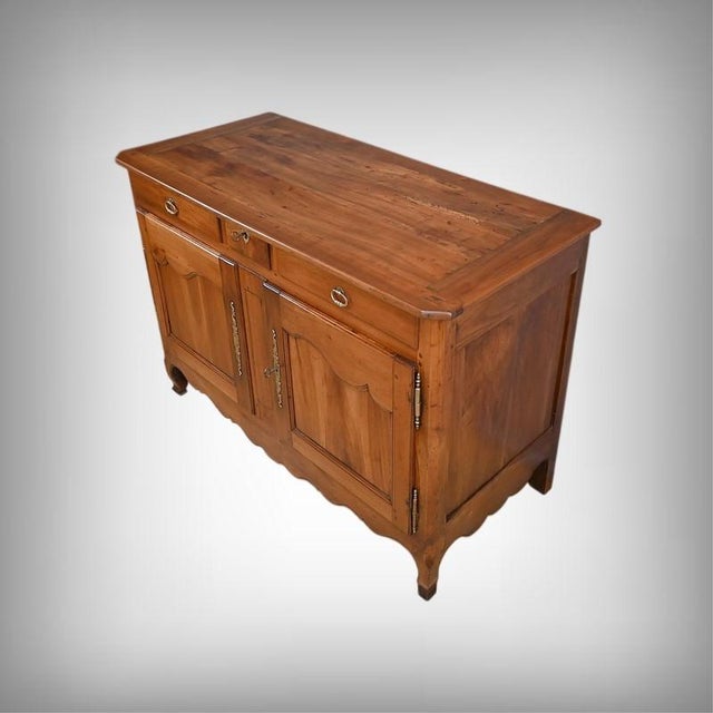 This superb solid cherrywood sideboard, dating from the mid-19th century, is distinguished by the warmth of its patinated...