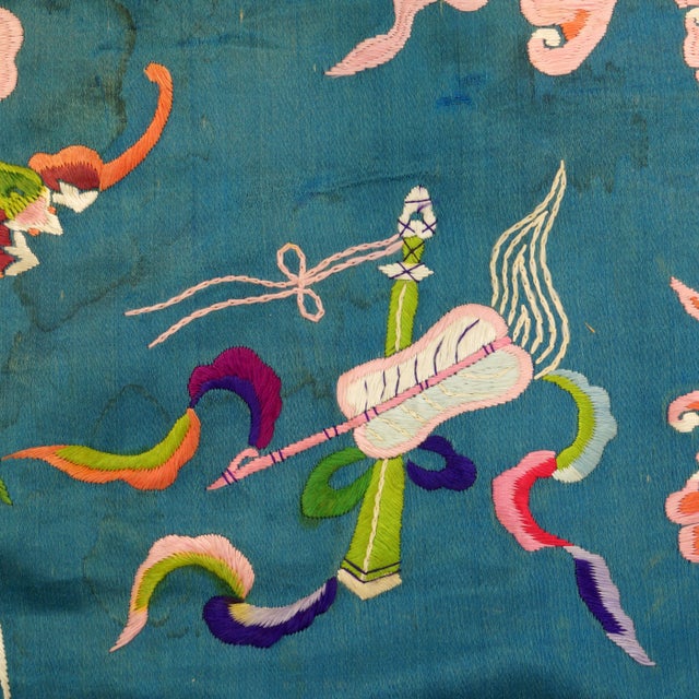 An antique Chinese turquoise silk embroidery panel, beautifully framed in silk damask. The vibrant textile features...
