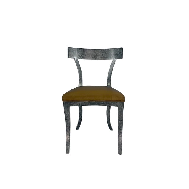 Stunning set of dining chairs with an elegant silhouette reminiscent of the Klismos style chair by T.H. Robsjohn-Gibbings....