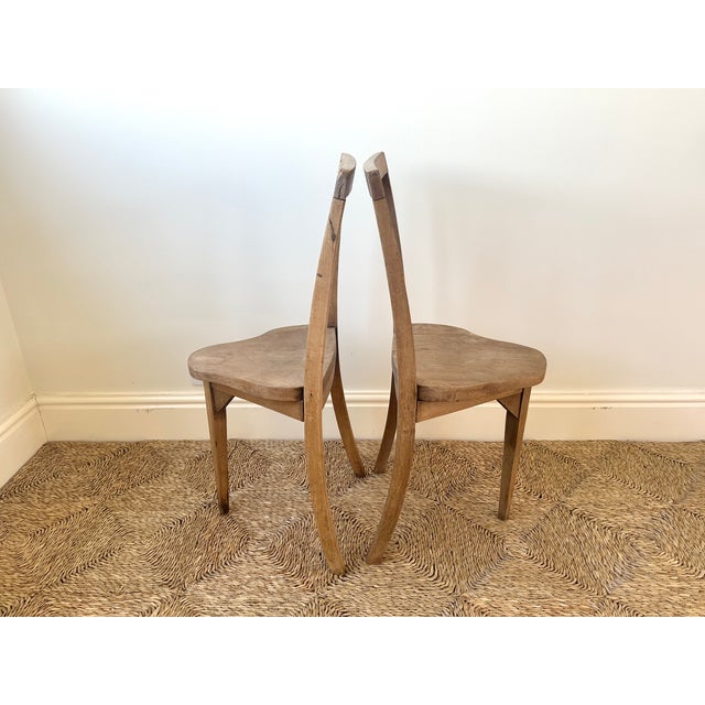 A beautifully understated pair of European vernacular chairs dating from the early to mid-20th century, handcrafted in...