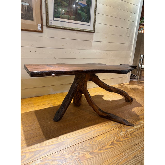 Studio Style tree trunk table has a rustic live-edge top, featuring a sculpted tree trunk base. Table is suitable as a...