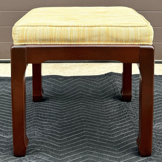 A vintage rosewood Ming style vanity bench or ottoman in yellow / gold fabric. Circa late 20th century, America. Measures...