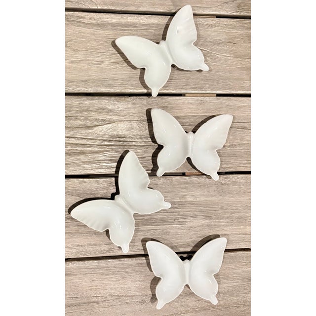 This set of four white porcelain butterfly dishes will add a touch of whimsey to any environment. They make charming...