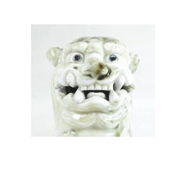 Fabulous karashishi of exquisite Hirado porcelain with a lively animated expression. Beautiful white porcelain accented...