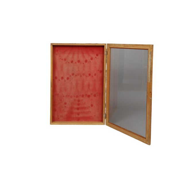 A 1960’s display case for Utica Tools. Made of oak, the case has a large glass front door with original Utica signs....