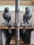 Rare 1940s table lamp featuring a pair of bronze parrots perched on a branch of faux bamboo. It casts a warm, inviting...