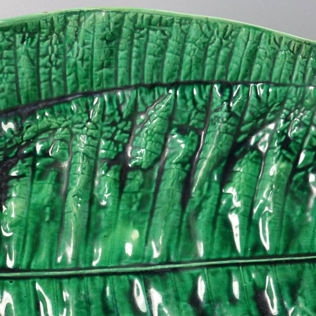 George Jones Majolica platter which features a banana leaf sitting on a branch-like base. Colouration: green, brown, are...