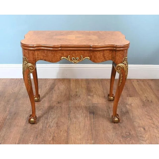 Queen Anne Style Ball and claw games table by Epstein and Co circa 1920 Fine Quality Burr Walnut with partial gilt...