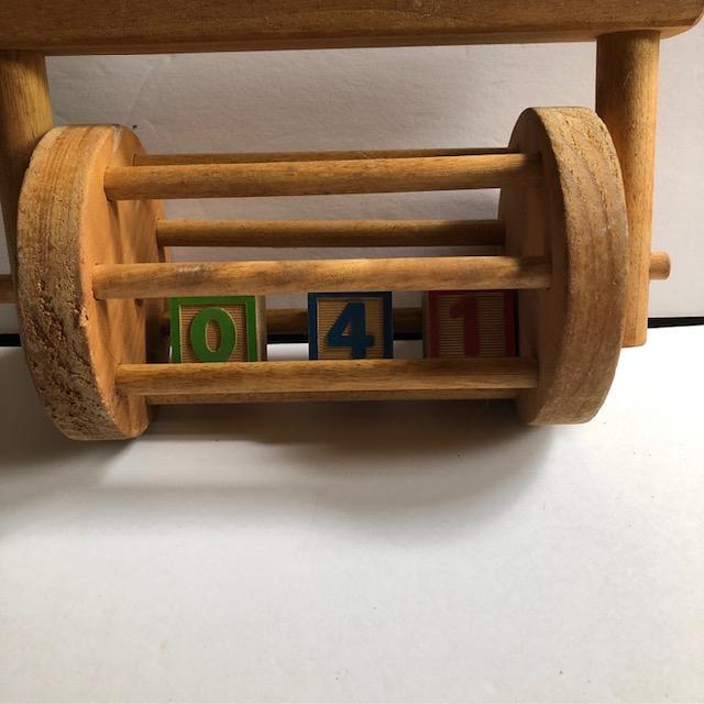 Sweet child's toy from mid-20th century. Numbered painted blocks tumble in a basket as the toy is pushed with a long...