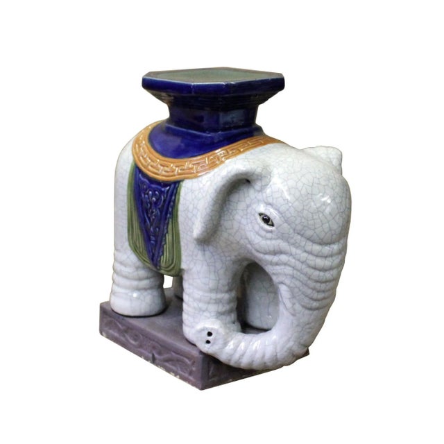 This is a traditional Chinese decorative elephant figure made of ceramic and glazed with off-white color with crackle...
