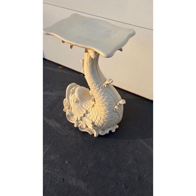 This is a wonderful Regency dolphin table. It looks like wood and the owners thought it was. It is made of a composite...