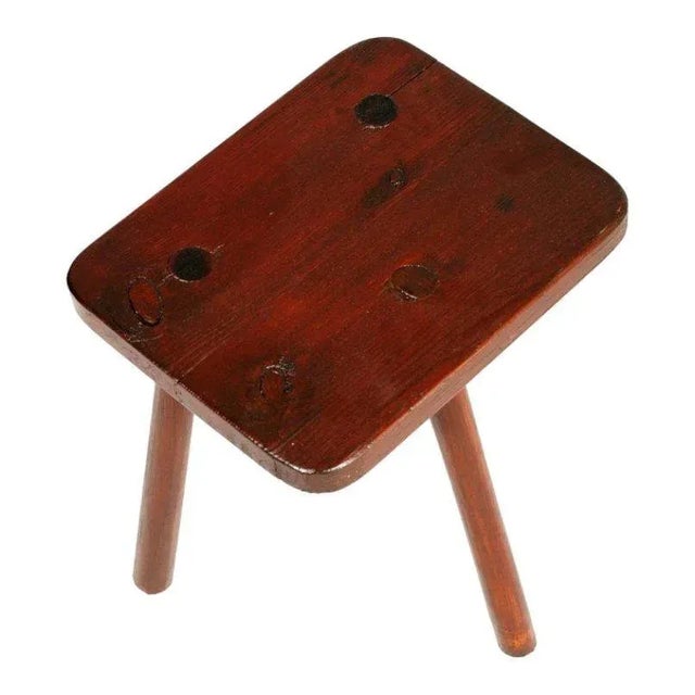 This restored tripod stool is made of wax-polished chestnut.
