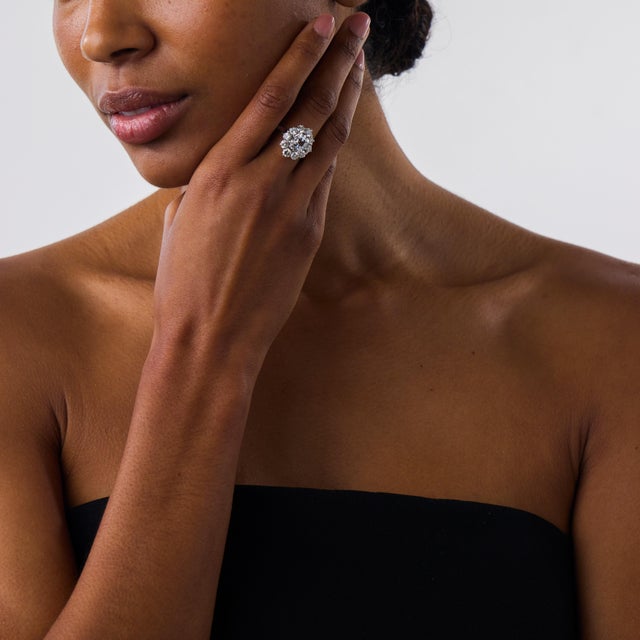 This beautiful Mid Century diamond cluster ring is a striking 1950’s design, centered by a GIA-certified old mine cut...