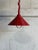 This vibrant hanging pendant fixture features a striking red metal shade with a unique ribbed design and an adjustable...