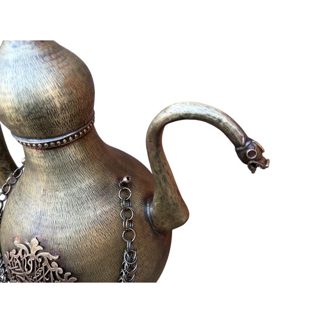 Brass ewer; moves beyond simple utility to stand as a complex piece of sculptural metalwork. Crafted for environments that...