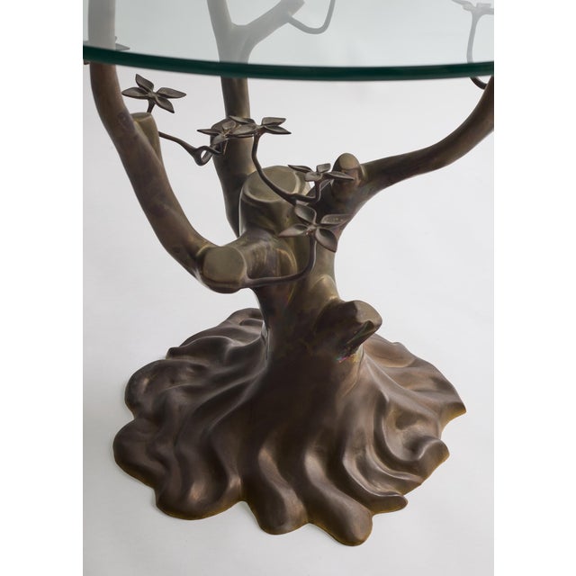 A sculptural Belgian bonsai table, circa 1970s, attributed to Willy Daro. The brass base takes the form of a stylized...