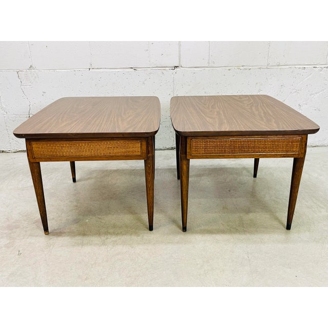 Vintage 1960s pair of rectangular side tables with wicker front drawers by American of Martinsville. The tables are in elm...