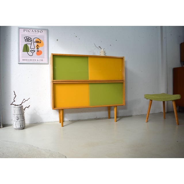 This is a modular vintage sideboard with glass sliding doors from the renowned German company Hellerau. Hellerau furniture...