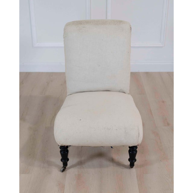 Beautiful 19th century French Napoleon III slipper chair featuring an elegant scroll back and refined proportions...