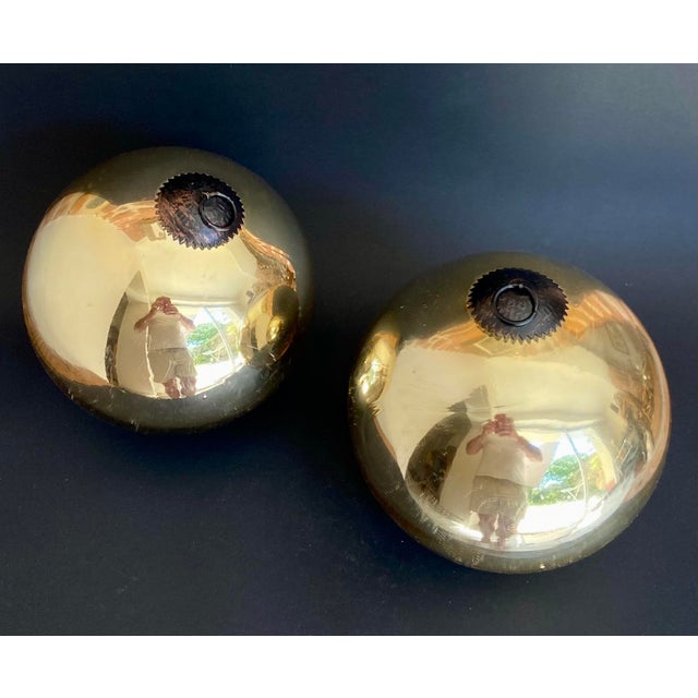 Exceptional pair of oversized French eglomisé glass decorative spheres dating from the mid-20th century. These sculptural...