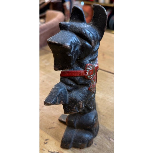 Original Painted Iron Scotty Dog Doorstop. black cast iron in amazing patina. The bow in the dog is painted red and has...