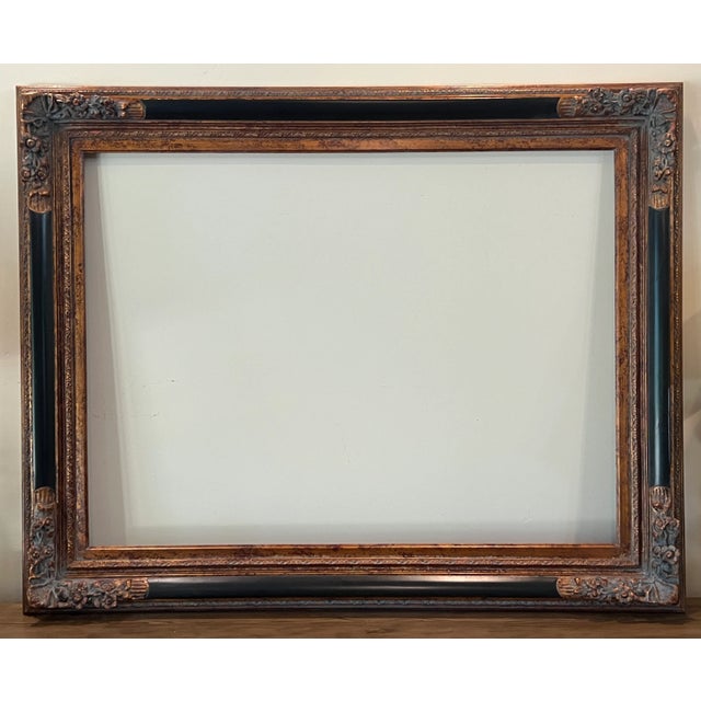 Large ornate Barque Revival Style Carved Wood Frame exudes old-world elegance with a lovely combination of ornate bronzed...